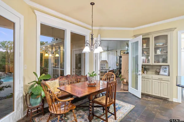 a view of a dining room with furniture and chandelier