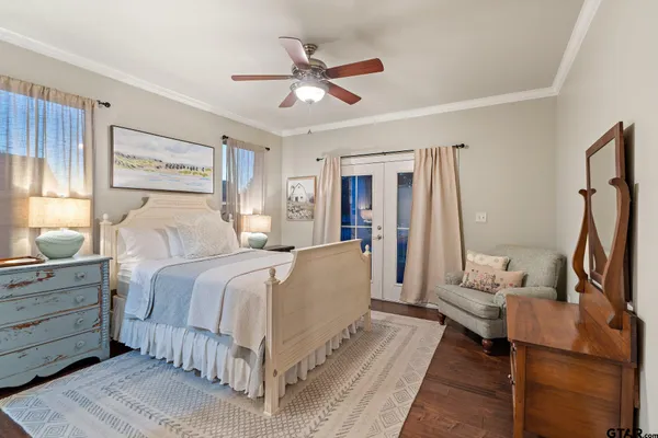 a bedroom with a large bed and a chandelier