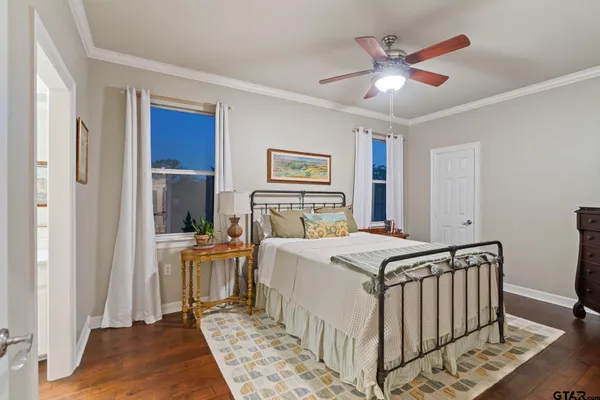 a bed sitting in a bedroom next to a window