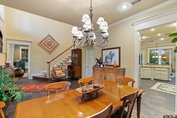 a dining room with furniture a livingroom and chandelier
