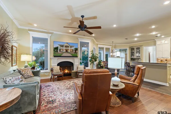 a living room with furniture a fireplace and a dining table