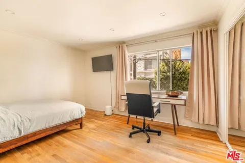 a bedroom with a bed and a desk