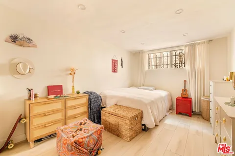 a bedroom with a bed and a couch