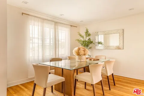 a dining room with furniture and wooden floor