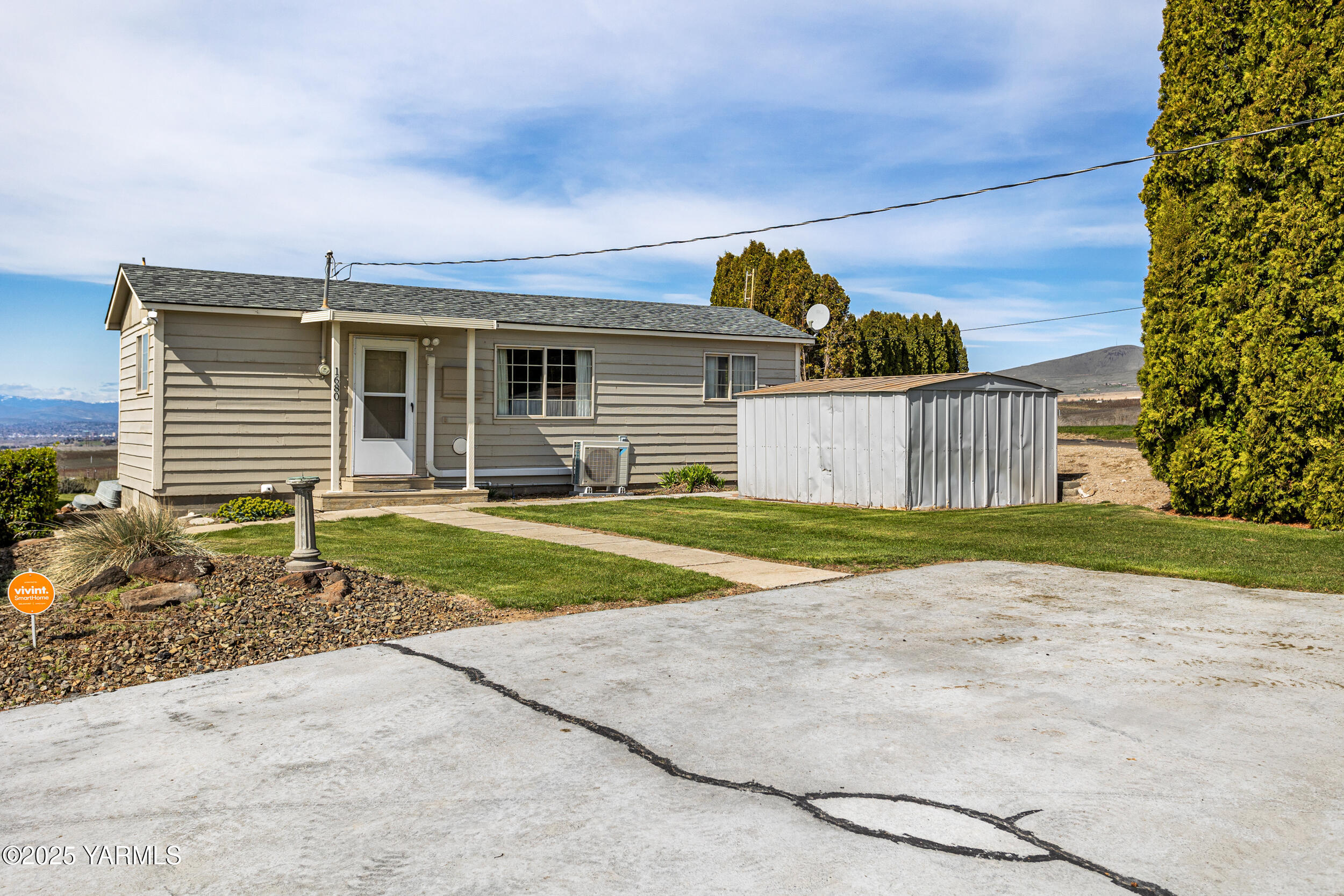 1680 St Hilaire Road Yakima, WA 98901 - Photo 1 of 22 a view of a house with backyard and a garage
