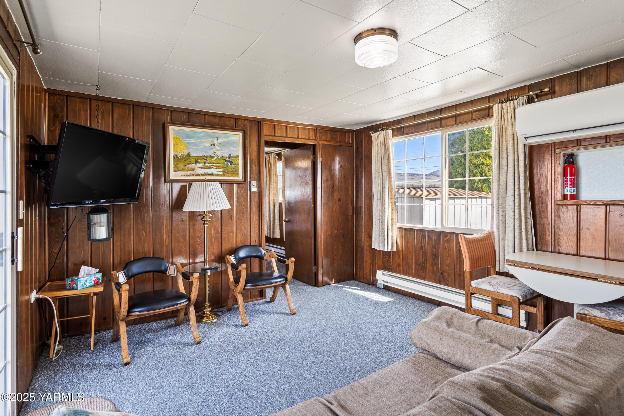 1680 St Hilaire Road Yakima, WA 98901 - Photo 6 of 22 a living room with furniture a flat screen tv and floor to ceiling window