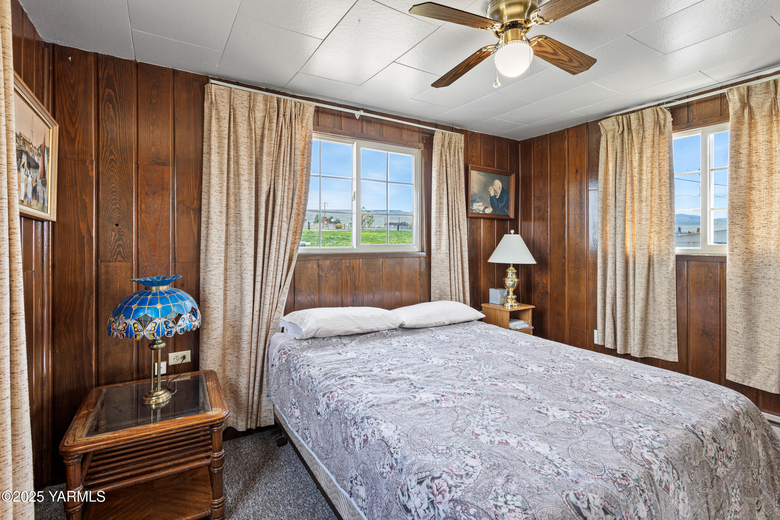 1680 St Hilaire Road Yakima, WA 98901 - Photo 9 of 22 a bedroom with a bed and a chandelier