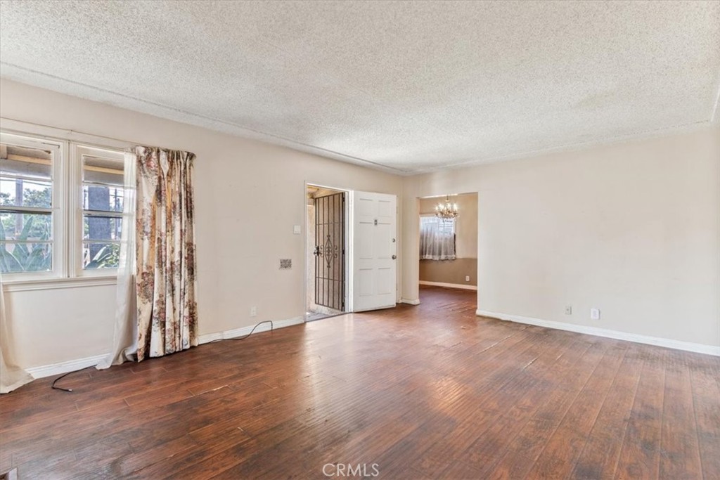5929 Norwalk Boulevard Whittier, CA 90606 - Photo 12 of 33 an empty room with wooden floor and windows