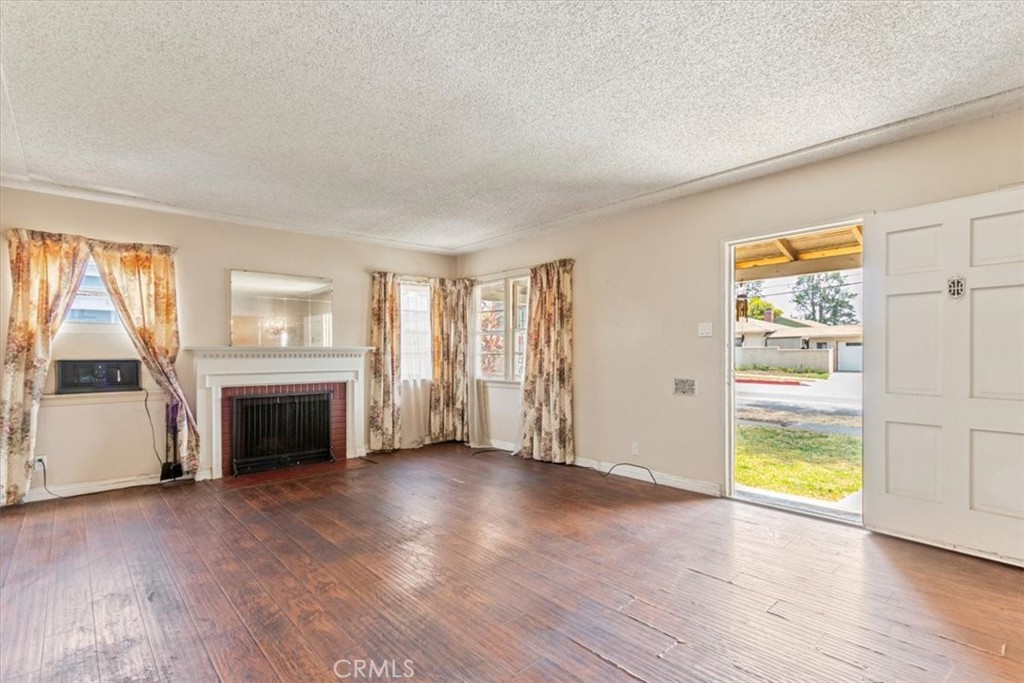 5929 Norwalk Boulevard Whittier, CA 90606 - Photo 15 of 33 an empty room with furniture and a fireplace