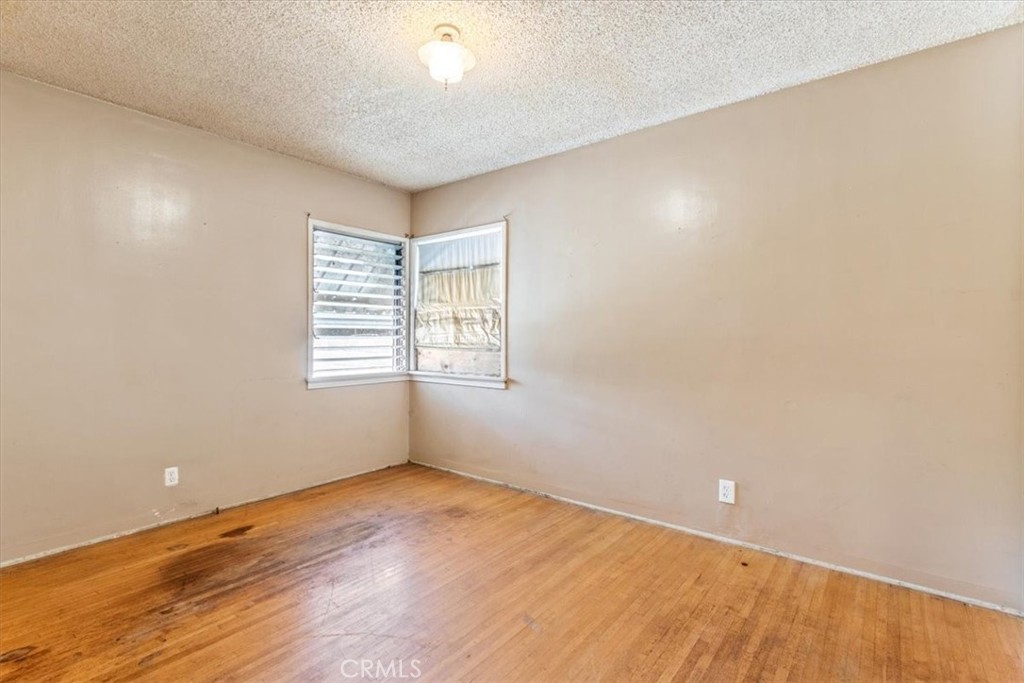 5929 Norwalk Boulevard Whittier, CA 90606 - Photo 16 of 33 an empty room with wooden floor and windows