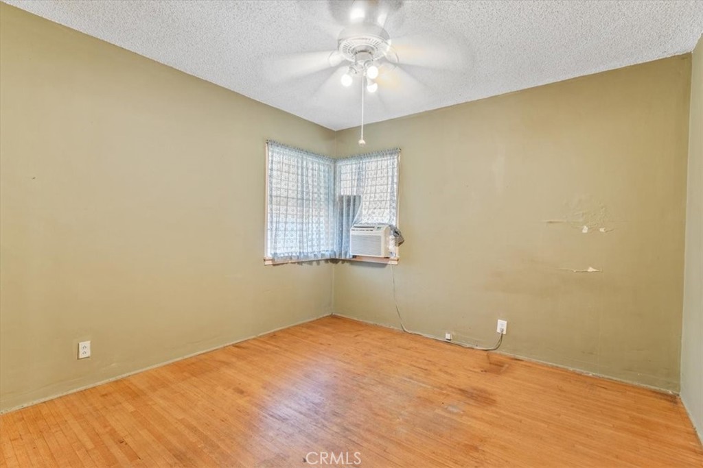 5929 Norwalk Boulevard Whittier, CA 90606 - Photo 19 of 33 an empty room with a chandelier fan and windows