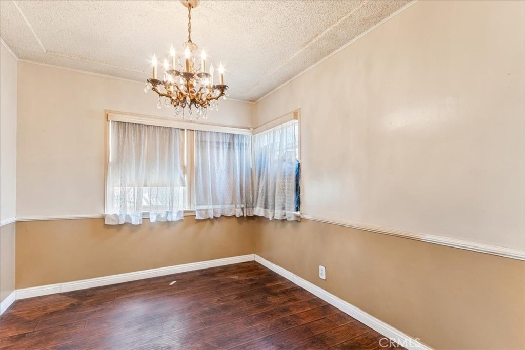 5929 Norwalk Boulevard Whittier, CA 90606 - Photo 24 of 33 an empty room with chandelier fan and windows