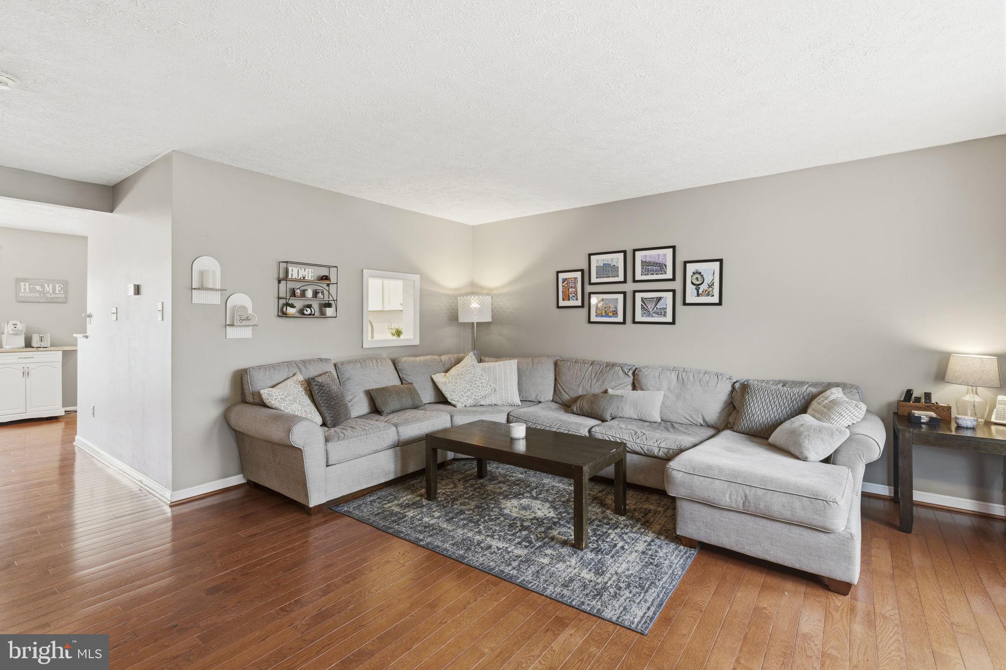 853 Comer Square Bel Air, MD 21014 - Photo 2 of 35 a living room with couches and a coffee table with wooden floor