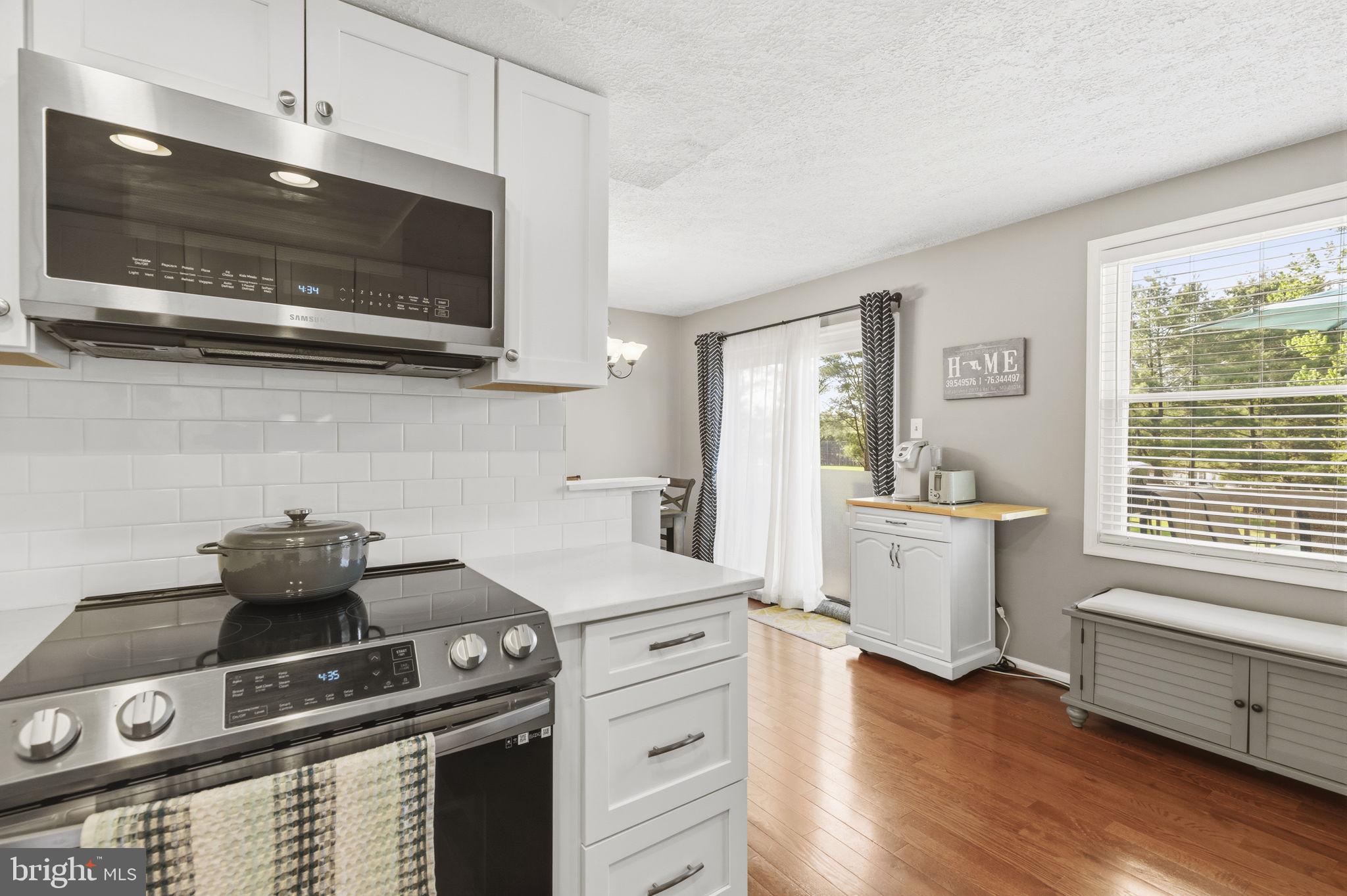 853 Comer Square Bel Air, MD 21014 - Photo 7 of 35 a kitchen with a stove and a microwave
