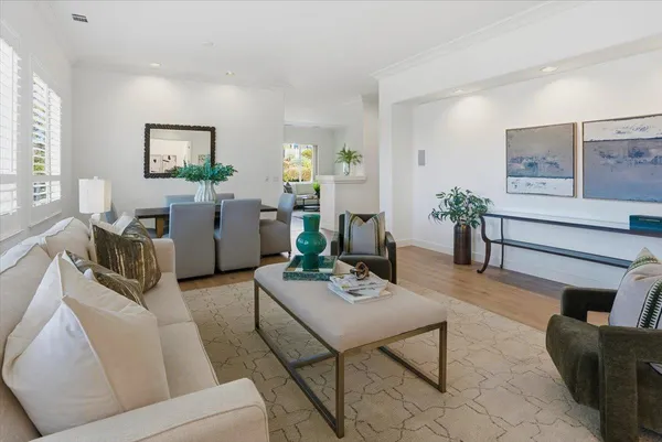 a living room with furniture and painting on the wall