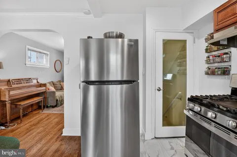 a kitchen with stainless steel appliances granite countertop a refrigerator and a stove top oven
