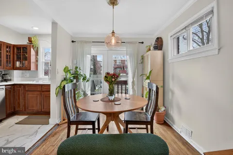 a view of a dining room with furniture and window