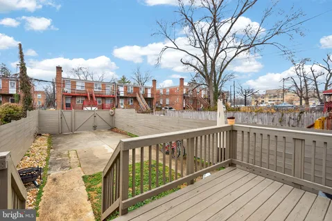 a view of a balcony with wooden fence