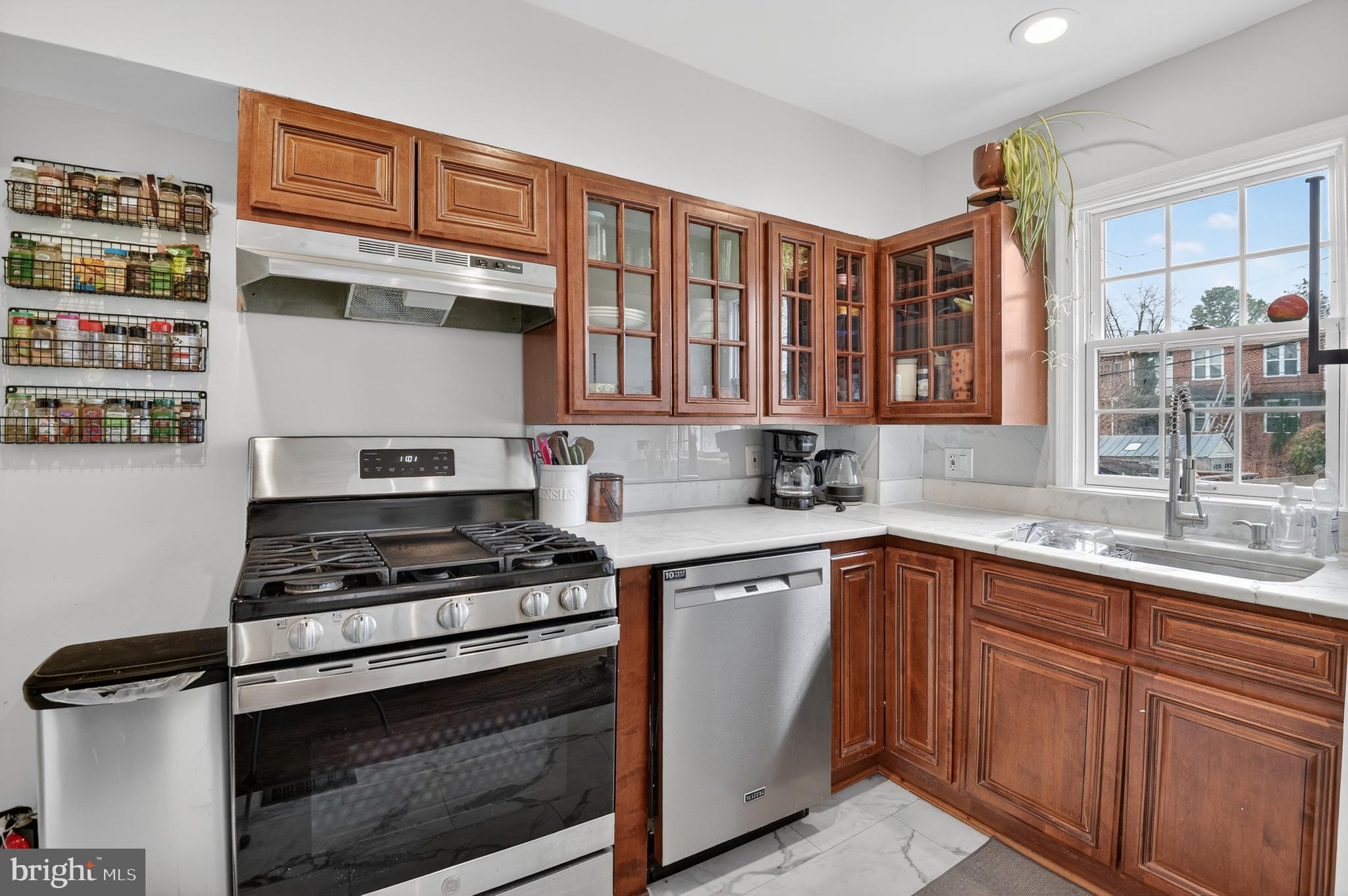 162 Forrester Street Southwest Washington, DC 20032 - Photo 9 of 28 a kitchen with stainless steel appliances granite countertop a stove and a sink