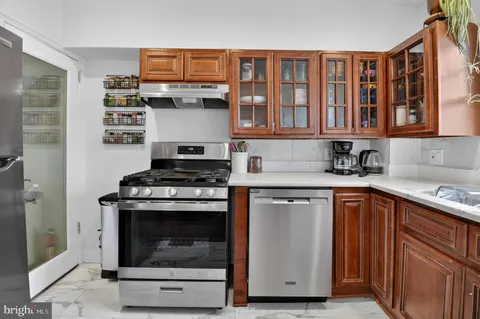 a kitchen with stainless steel appliances granite countertop a stove and a sink