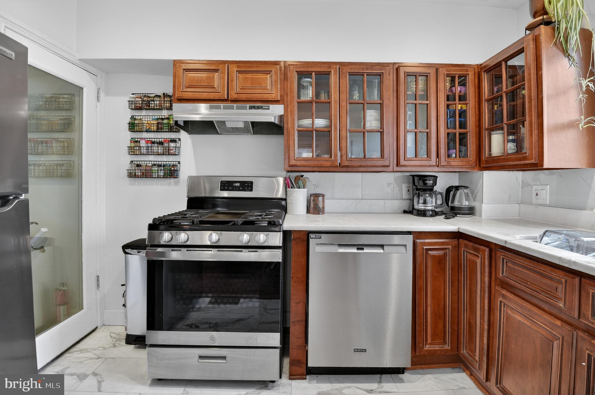 162 Forrester Street Southwest Washington, DC 20032 - Photo 10 of 28 a kitchen with stainless steel appliances granite countertop a stove and a sink