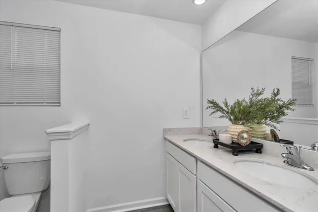 a bathroom with a shower a toilet and a sink