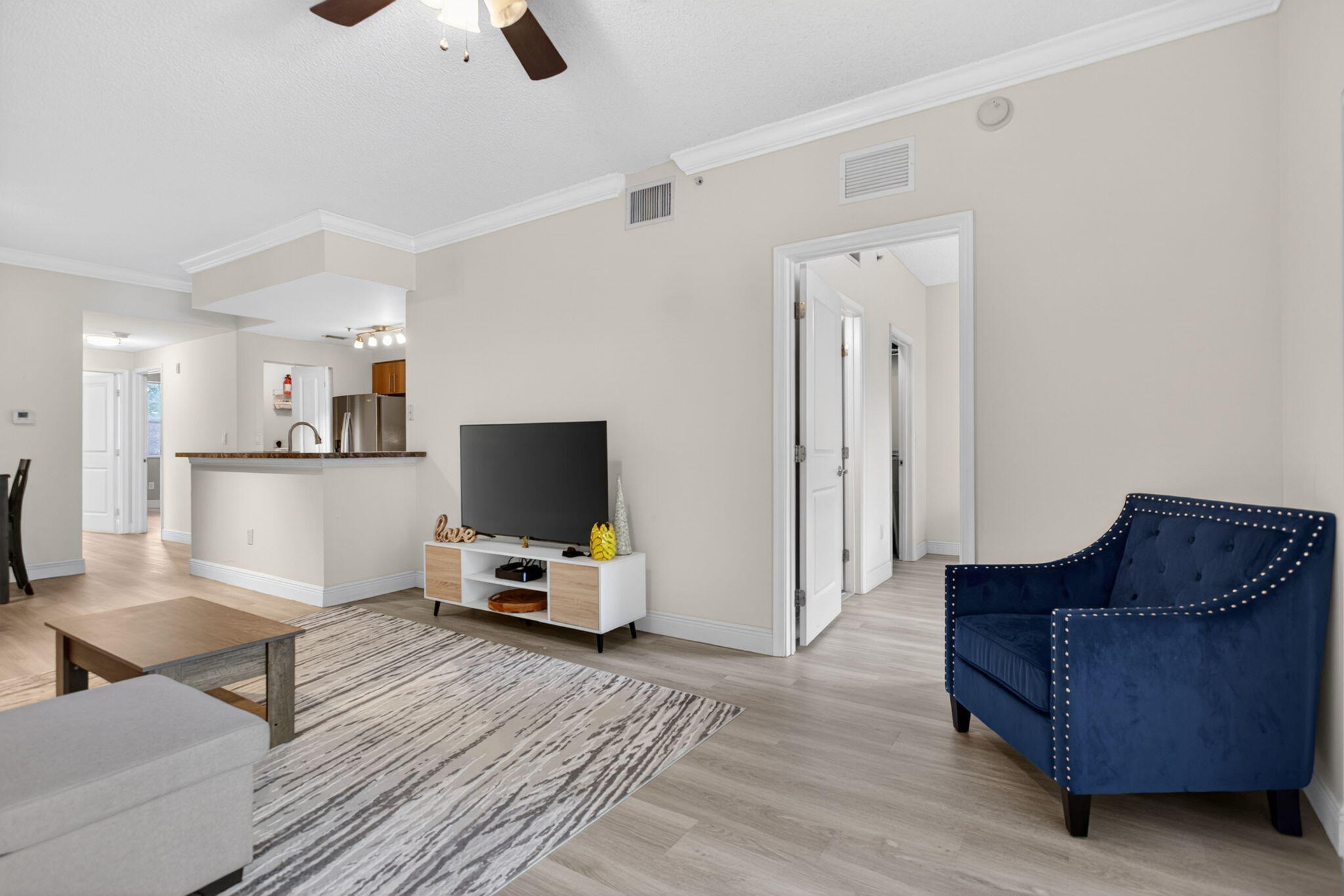 5880 West Sample Road, Unit 206 Coral Springs, FL 33067 - Photo 12 of 37 a living room with furniture and a flat screen tv
