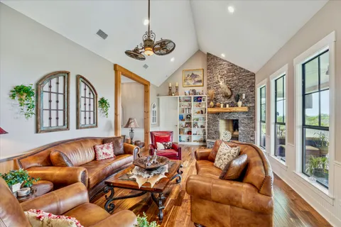 a living room with furniture a chandelier and a fireplace