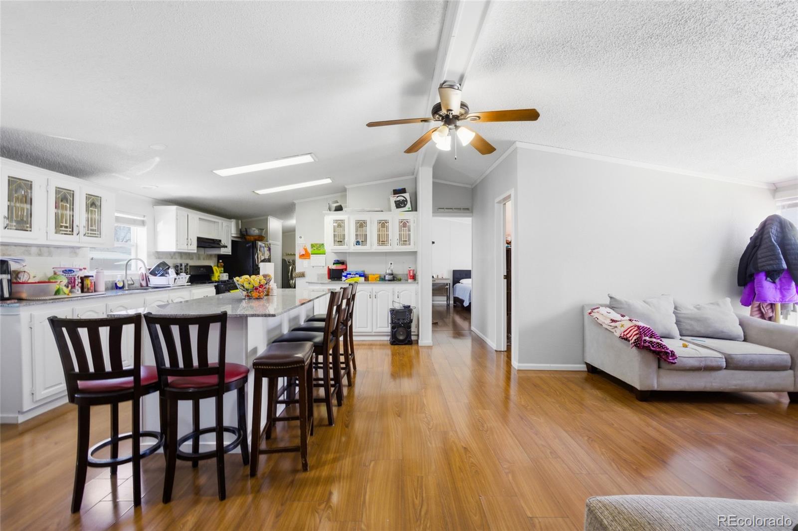 1724 Clark Street Aurora, CO 80011 - Photo 8 of 19 a living room with furniture and kitchen view