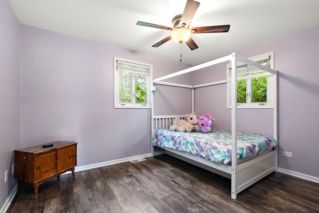 a bedroom with bed and a chandelier