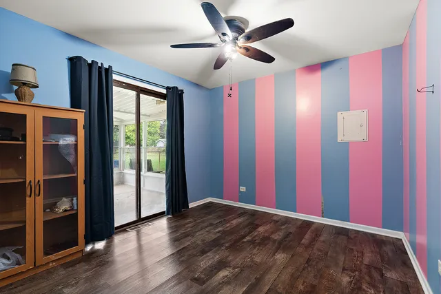 a view of a livingroom with a ceiling fan and window