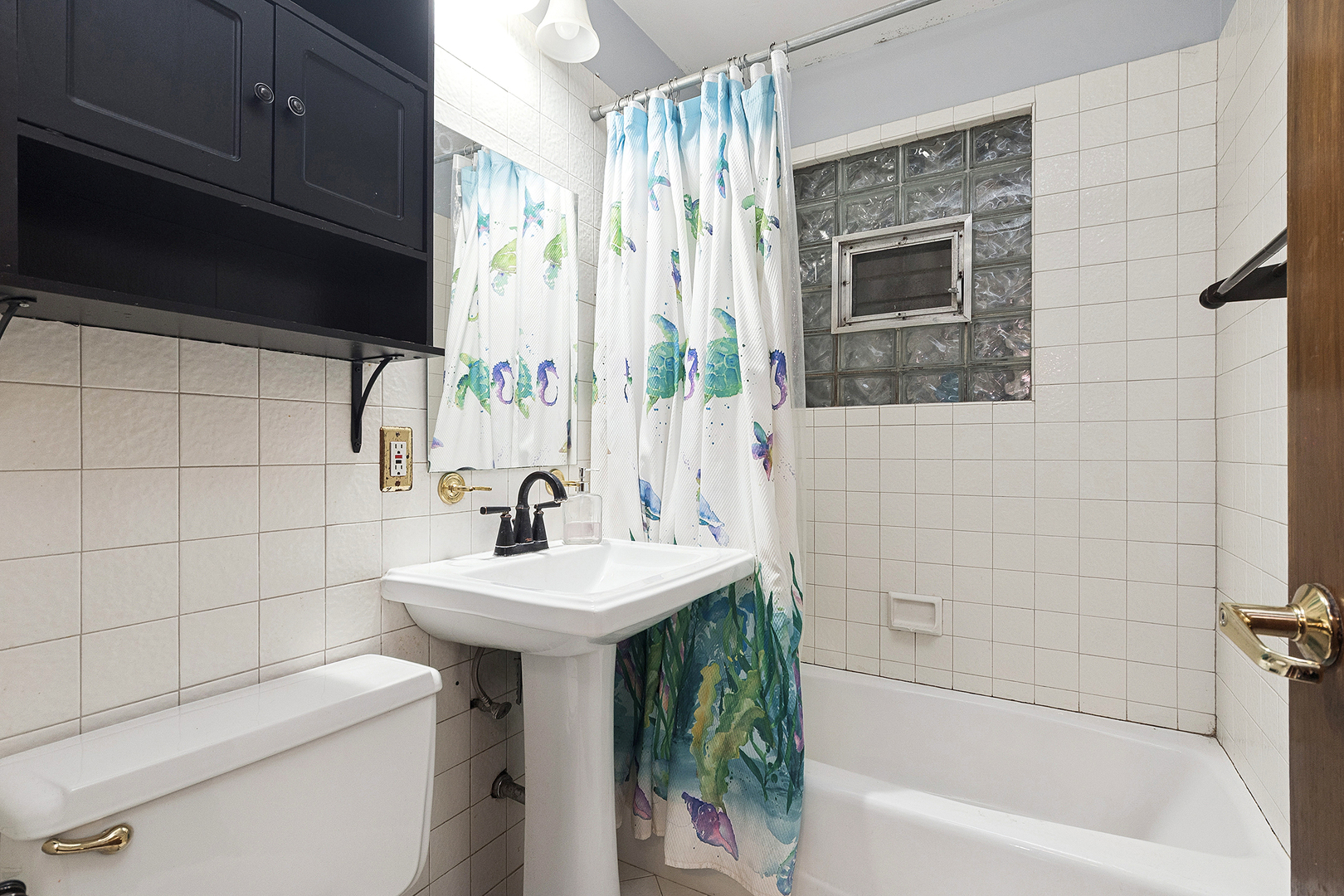 3129 Butler Avenue Steger, IL 60475 - Photo 13 of 20 a bathroom with a sink a toilet and shower