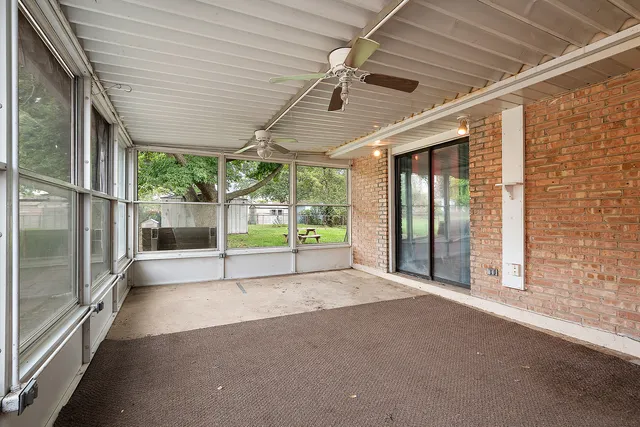 a view of an empty room with wooden floor and a sliding door