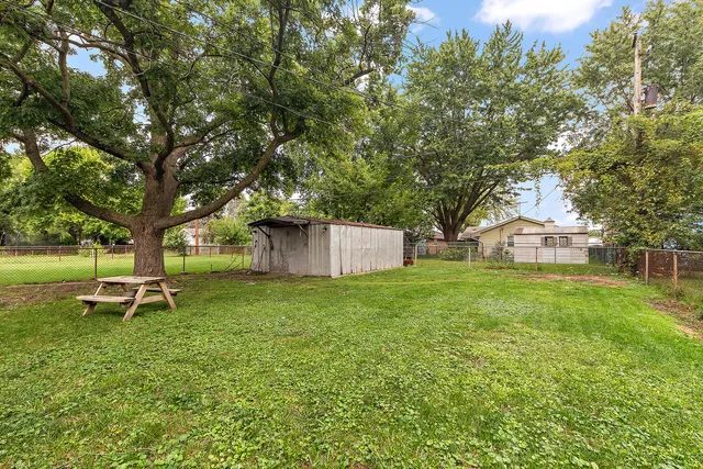 a garden with trees in front of it