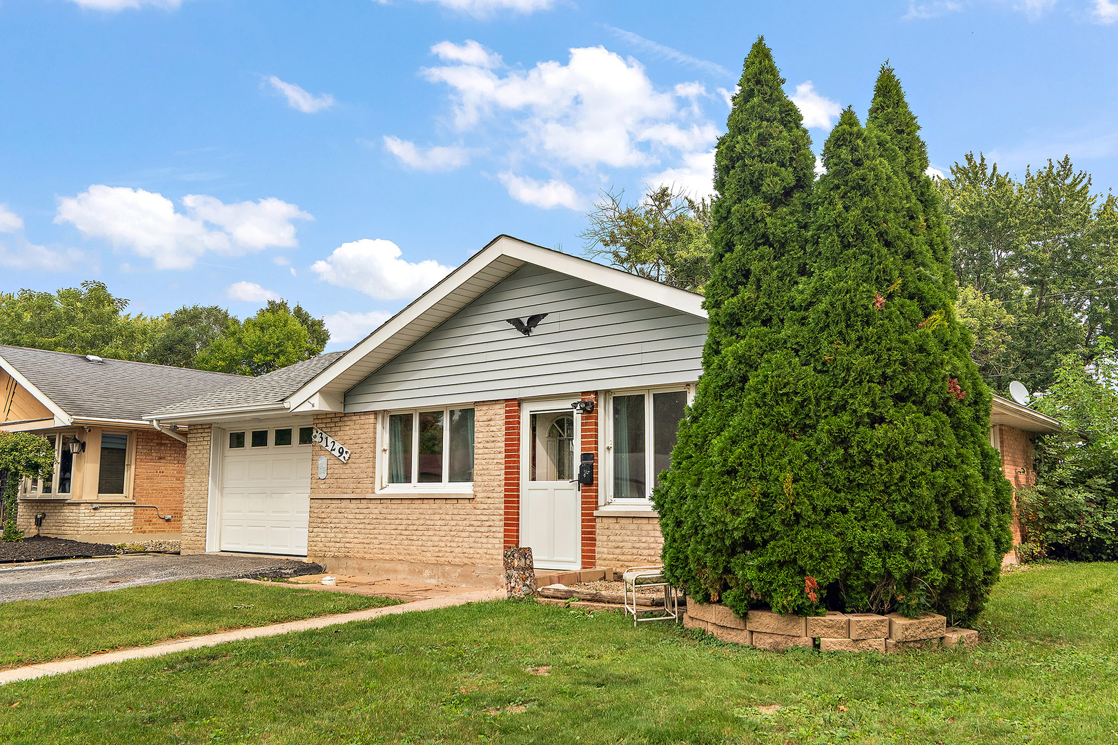3129 Butler Avenue Steger, IL 60475 - Photo 2 of 20 a front view of a house with a garden