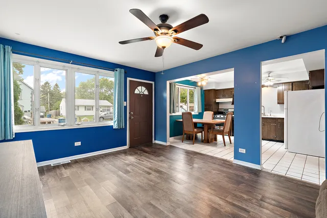 a living room with furniture and large windows