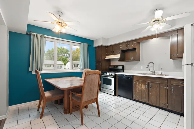 a view of a dining room with furniture a chandelier and window
