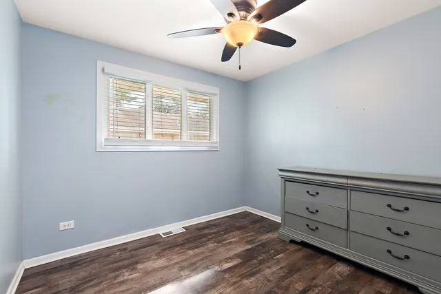 a view of an empty room with a window and closet
