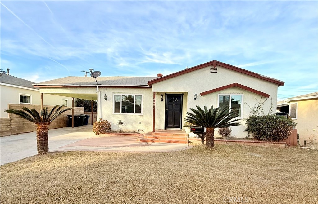 8803 Laurel Street Bellflower, CA 90706 - Photo 1 of 18 a front view of a house with a yard and potted plants