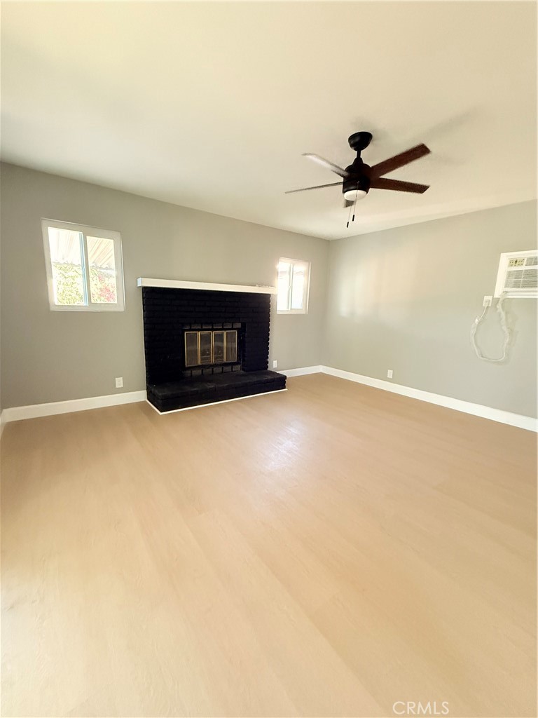 8803 Laurel Street Bellflower, CA 90706 - Photo 13 of 18 an empty room with windows and ceiling fan