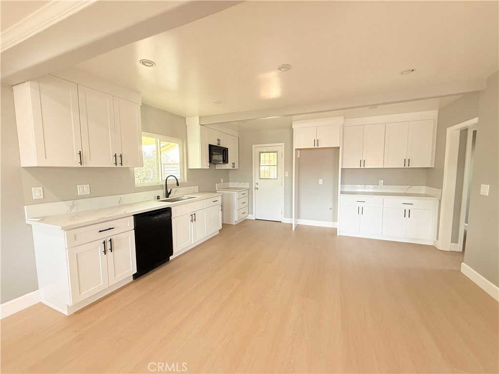8803 Laurel Street Bellflower, CA 90706 - Photo 7 of 18 a kitchen with stainless steel appliances a refrigerator sink and cabinets