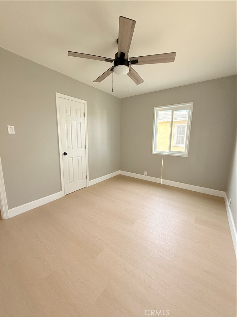 8803 Laurel Street Bellflower, CA 90706 - Photo 8 of 18 an empty room with a window and a fan