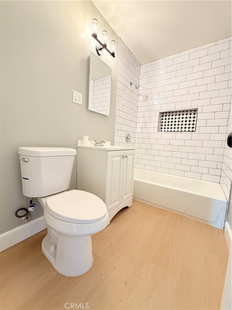 8803 Laurel Street Bellflower, CA 90706 - Photo 9 of 18 a bathroom with a toilet and a bathtub