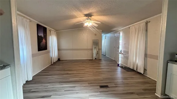 a view of a hallway view with wooden floor and staircase
