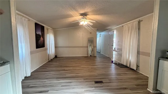 a view of a hallway view with wooden floor and staircase