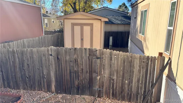 a view of a house with wooden fence