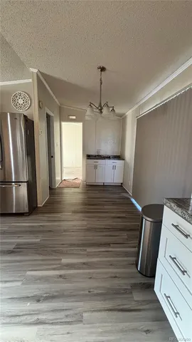 a room with a bed wooden floor and window