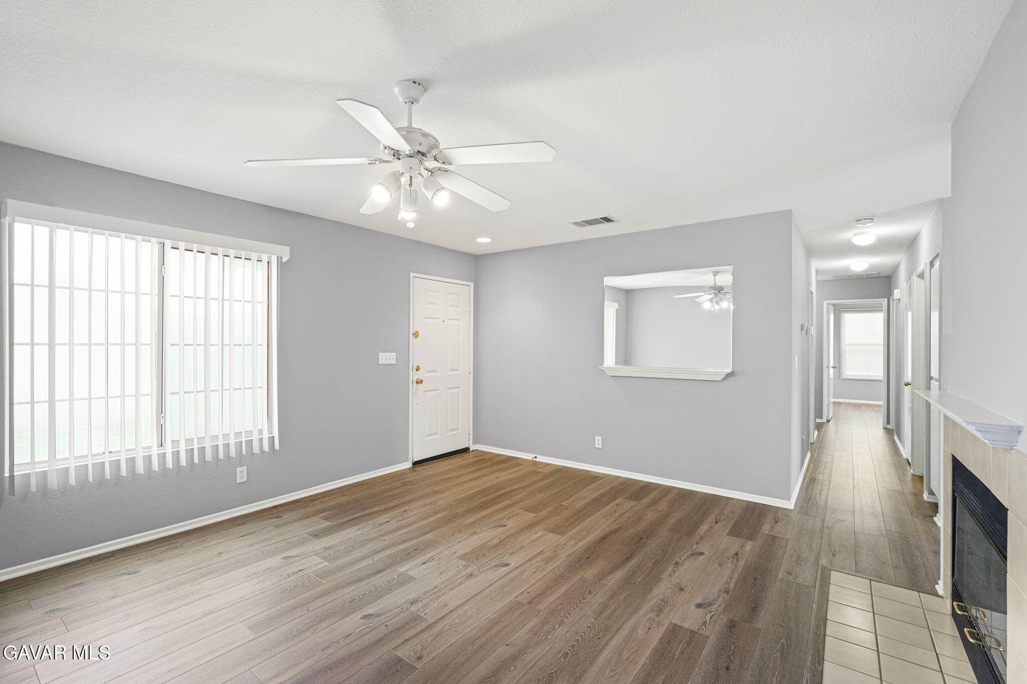 2108 Manchester Street Rosamond, CA 93560 - Photo 12 of 41 wooden floor in an empty room with a window