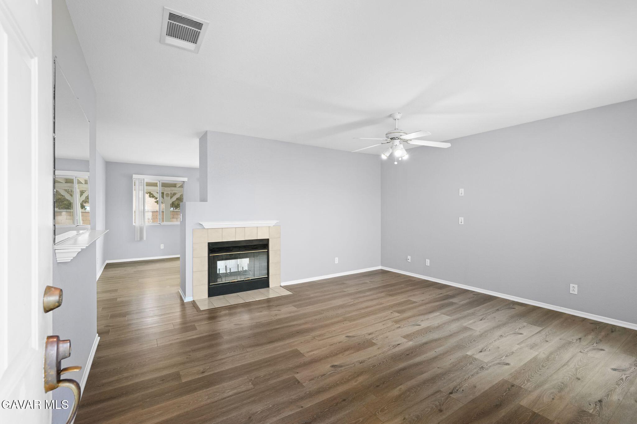 2108 Manchester Street Rosamond, CA 93560 - Photo 13 of 41 an empty room with windows and a fireplace