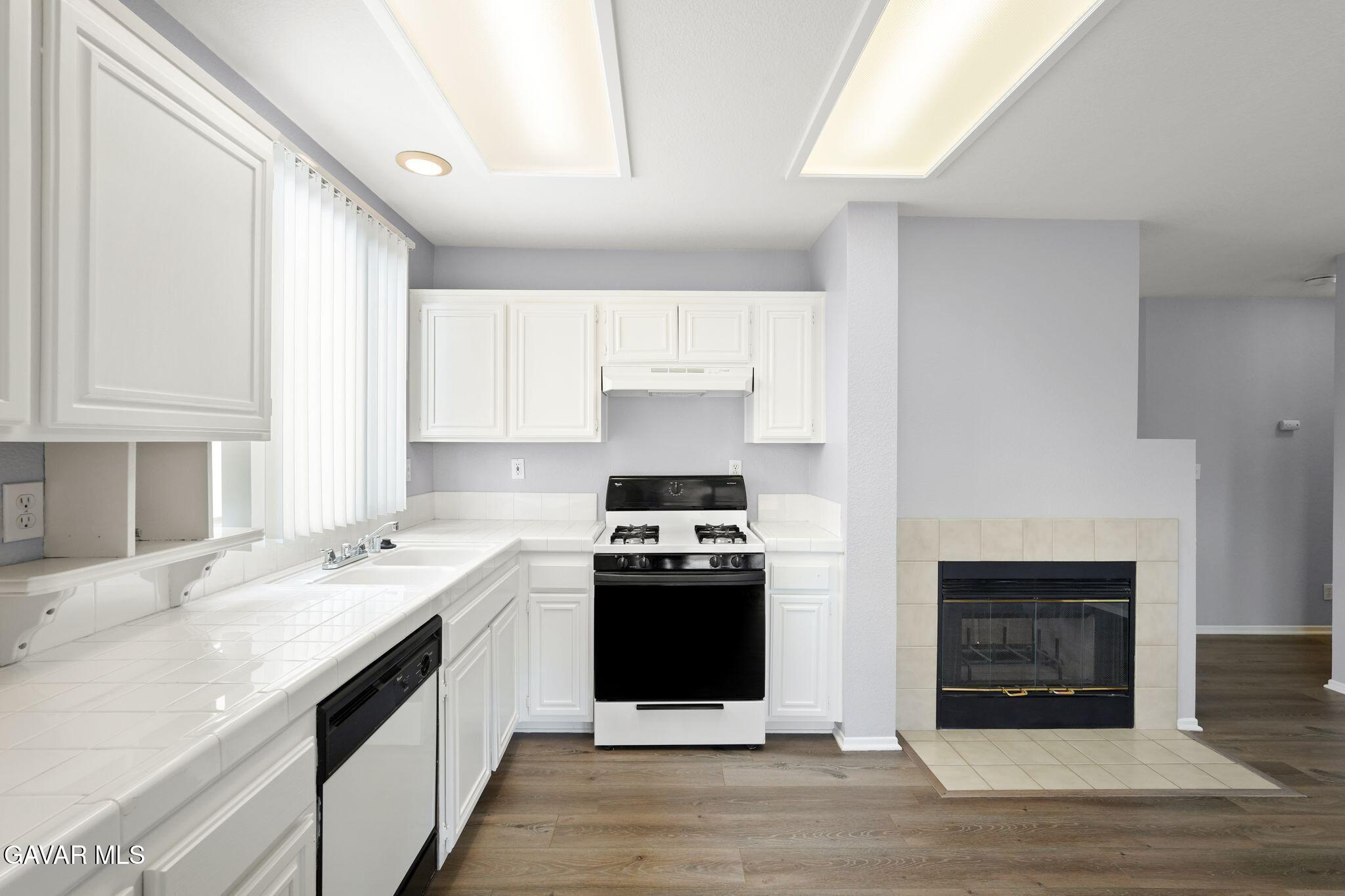 2108 Manchester Street Rosamond, CA 93560 - Photo 19 of 41 a kitchen with stainless steel appliances granite countertop a stove and a refrigerator